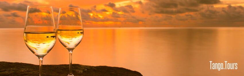 A sunset over the ocean with clouds in the sky.