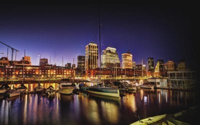 A city skyline with boats in the water.